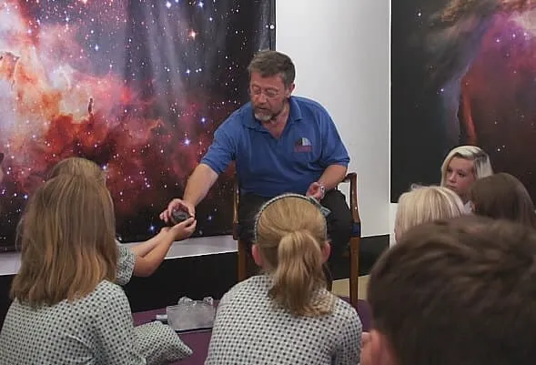   Children Handling meteorites.